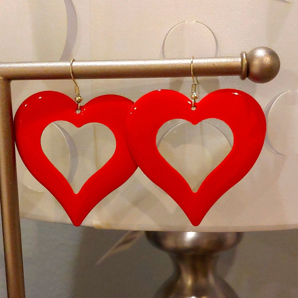 Dangling red heart earrings.